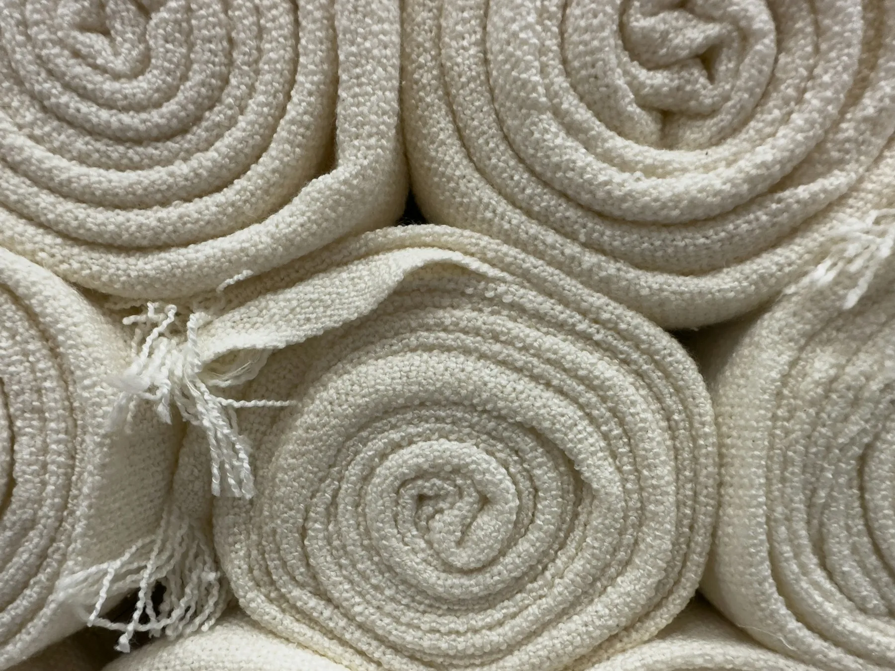 Rolled white towels stacked together